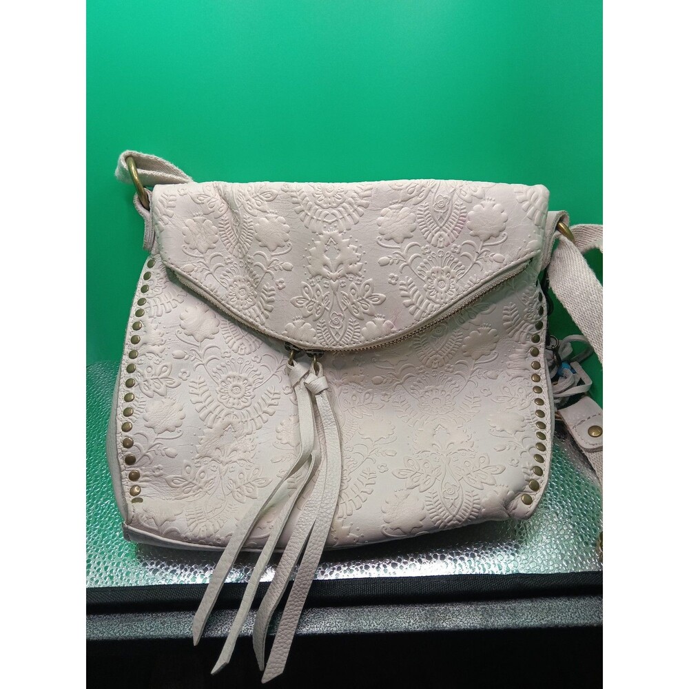 The Sak Silverlake Crossbody bag in an ivory floral-embossed leather with tassel